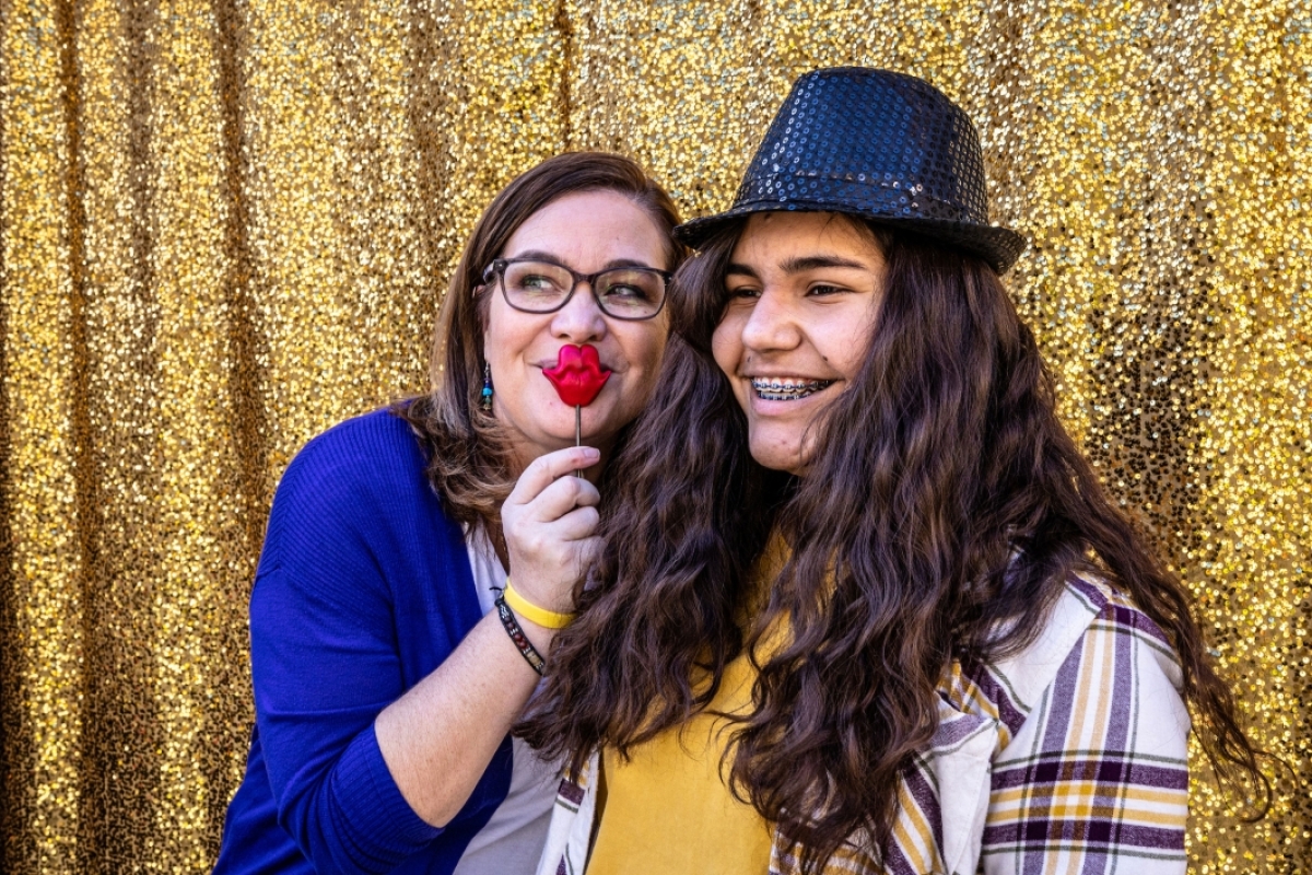 Mother and daughter take a picture at photo booth