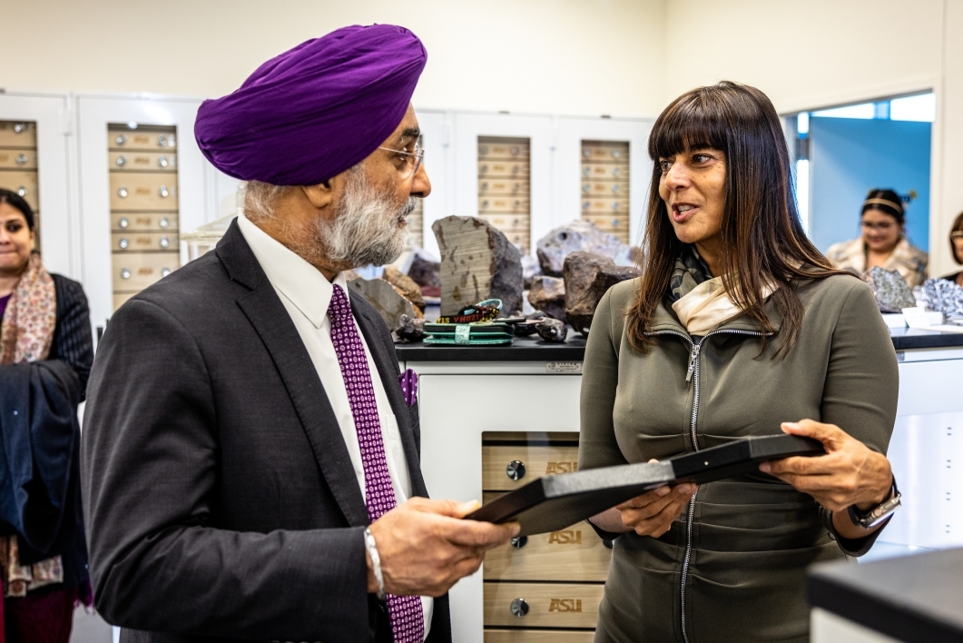Woman speaking to ambassador from India in meteorite gallery