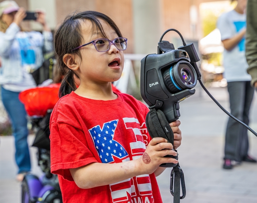 Young girl handles a thermal camera during Open Door event