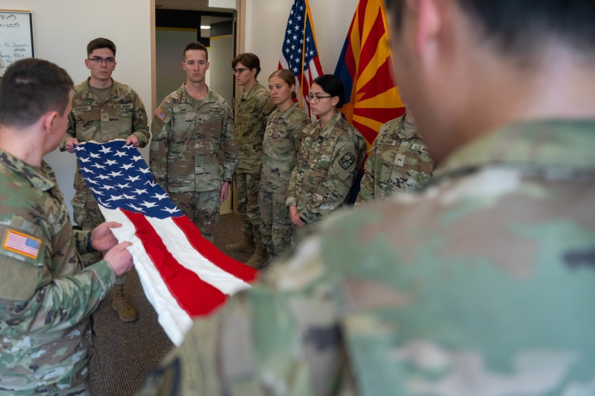 Army ROTC cadets unfolding US flag