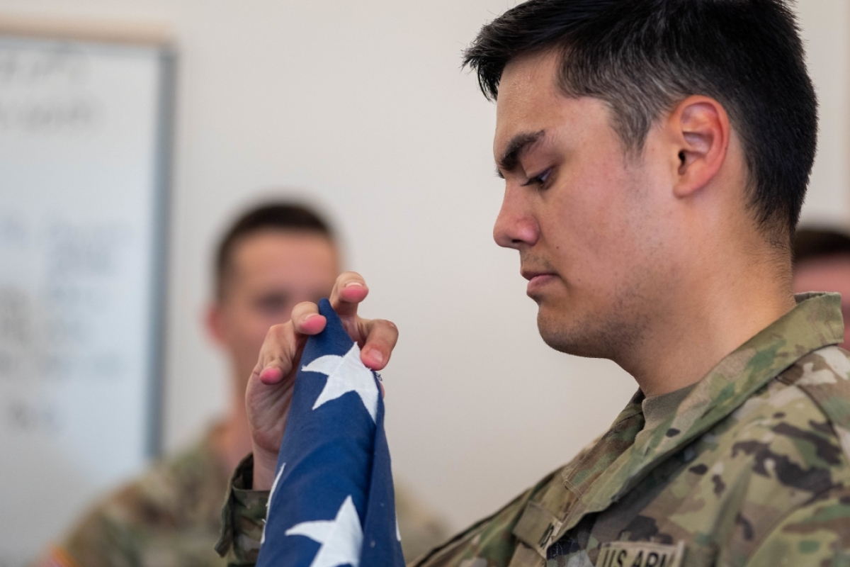 Army ROTC cadet checking folded corner of US flag