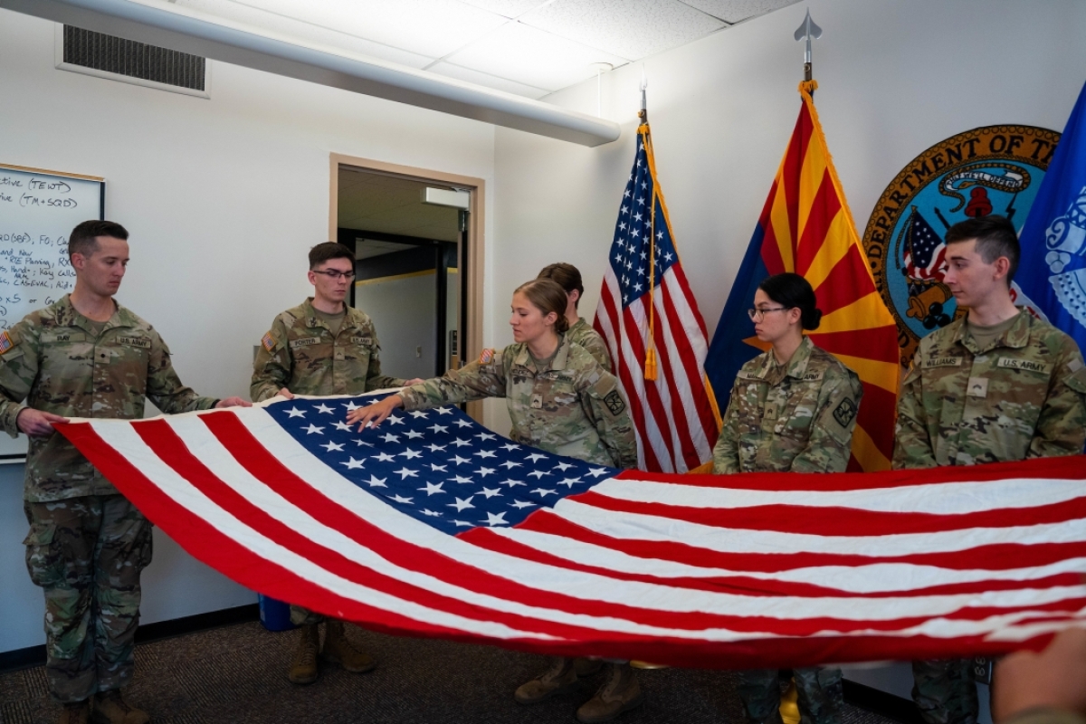 Army ROTC cadets holding unfolded US flag with 48 stars