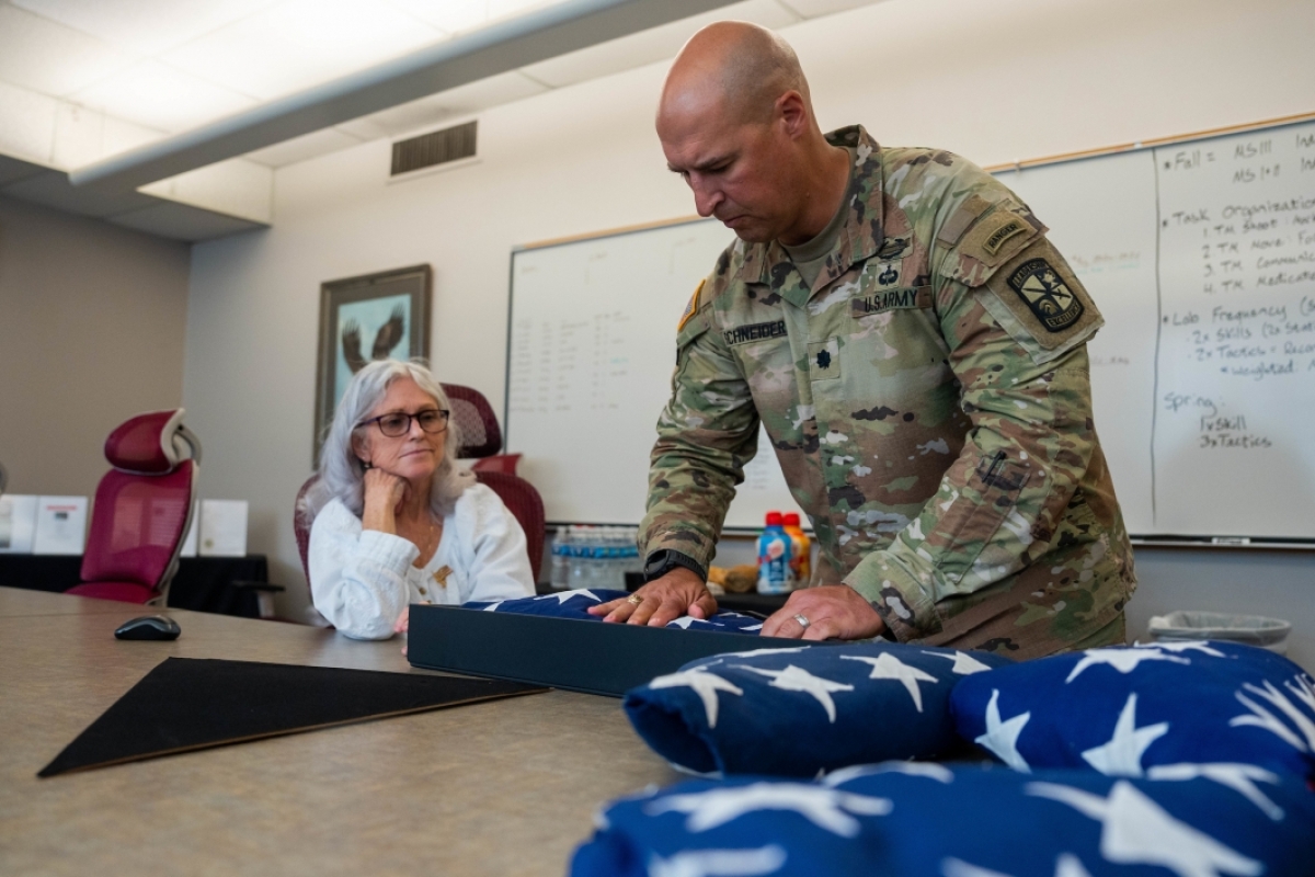 Lt. Col. placing a U.S. casket flag into a keepsake box