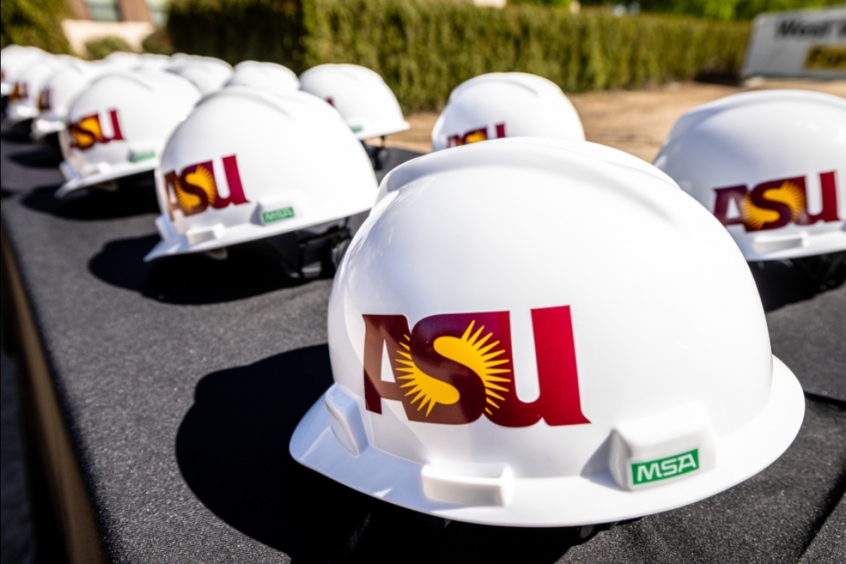 Construction hats with the ASU logo sit on a table