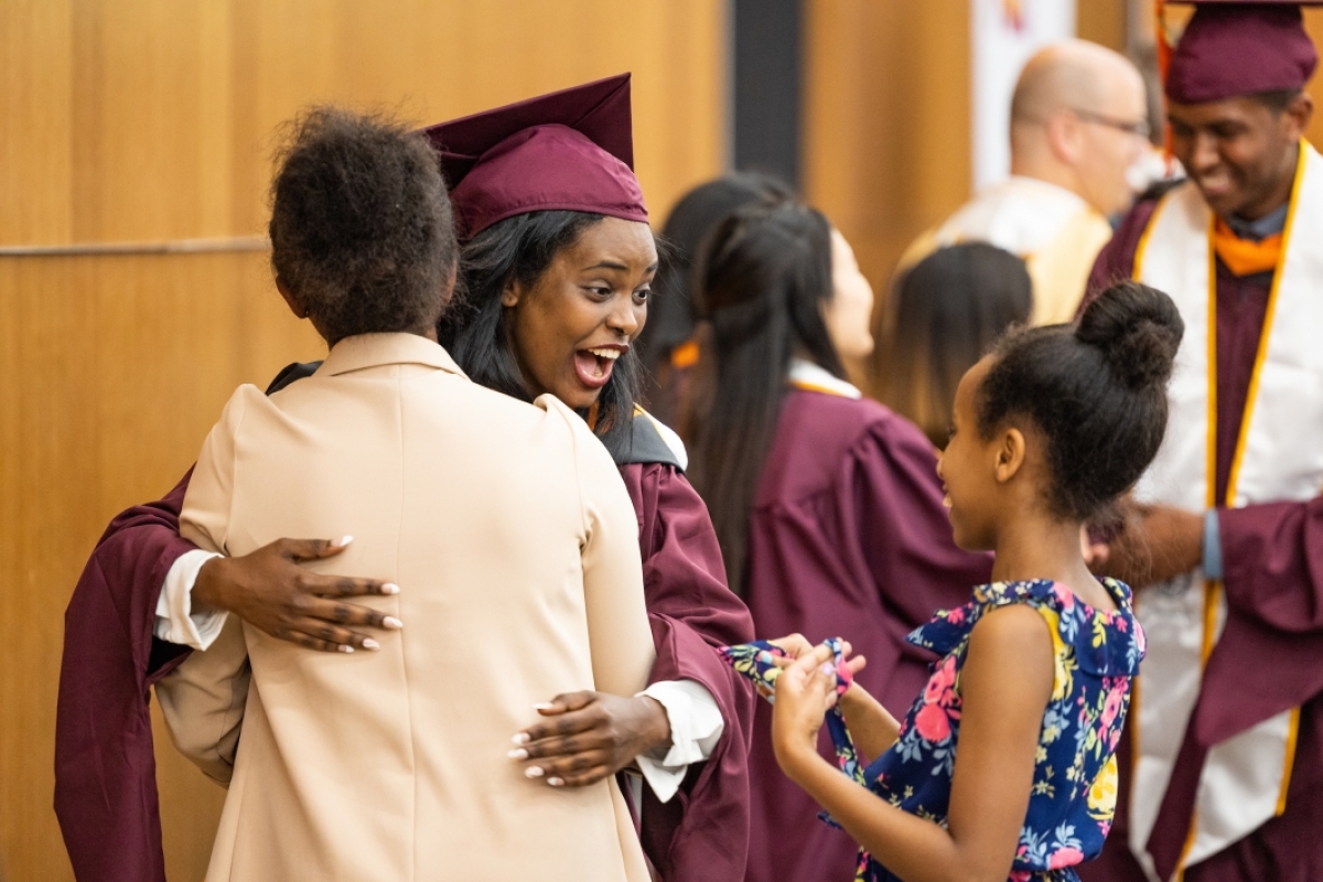 Woman hugging family at convocation