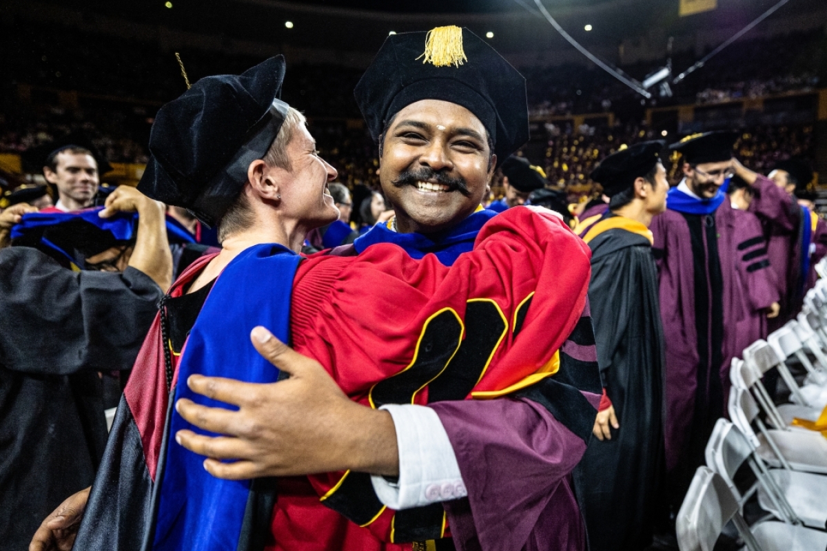 Graduate and advisor hugging at convocation