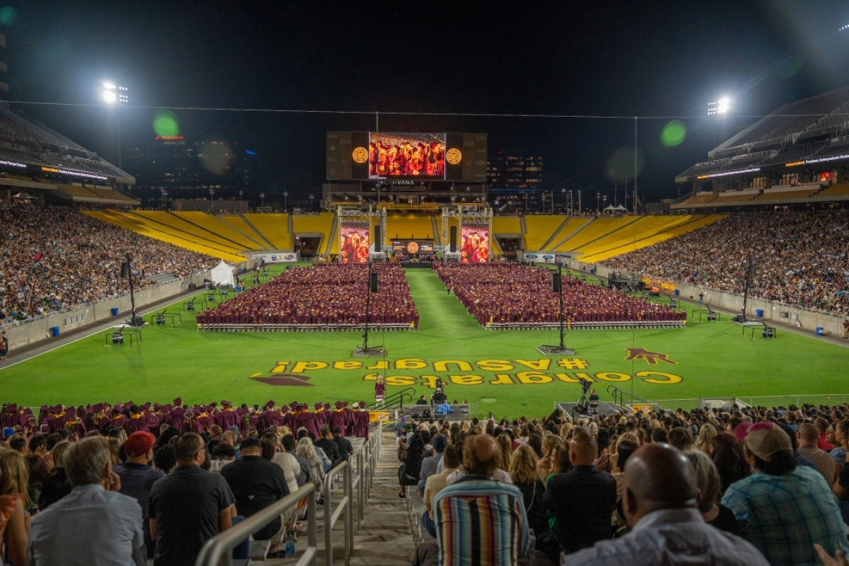 Graduates fill the field at the ASU football stadium