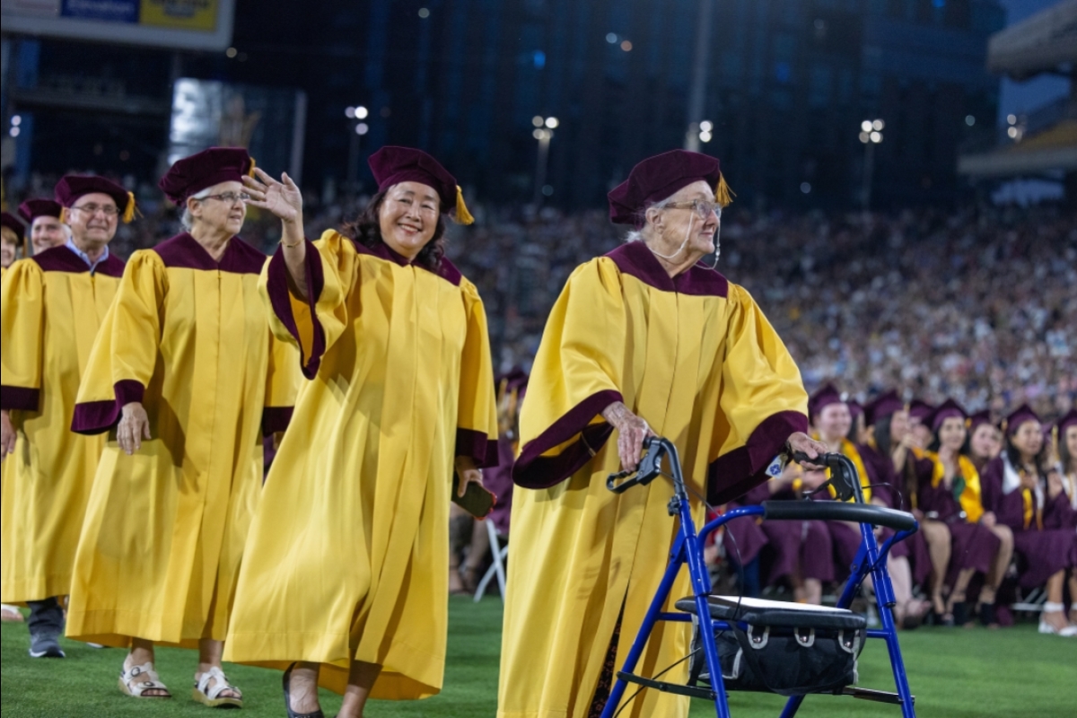 Golden Graduates walking into stadium during convocation