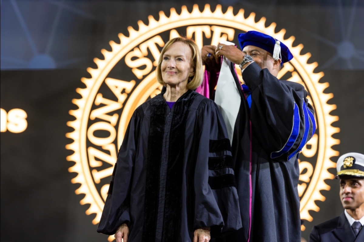 Woman receiving honorary hood during commencement