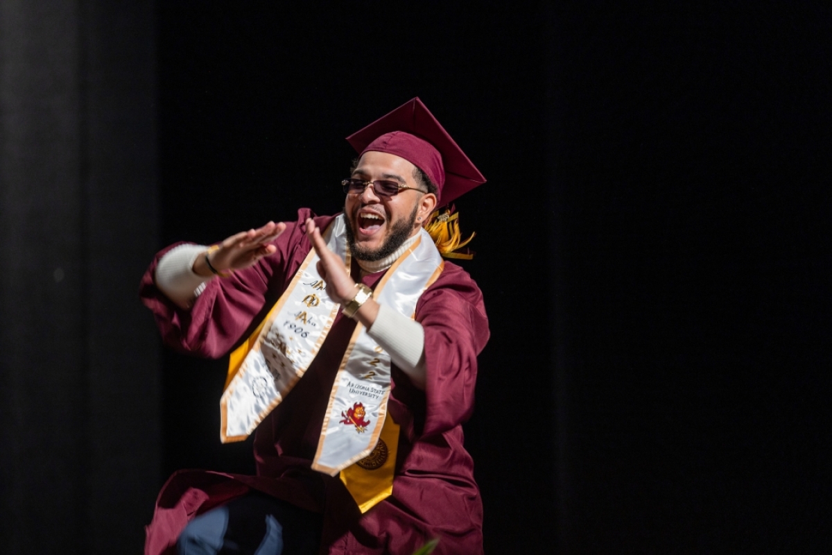 Graduate dancing across stage at convocation