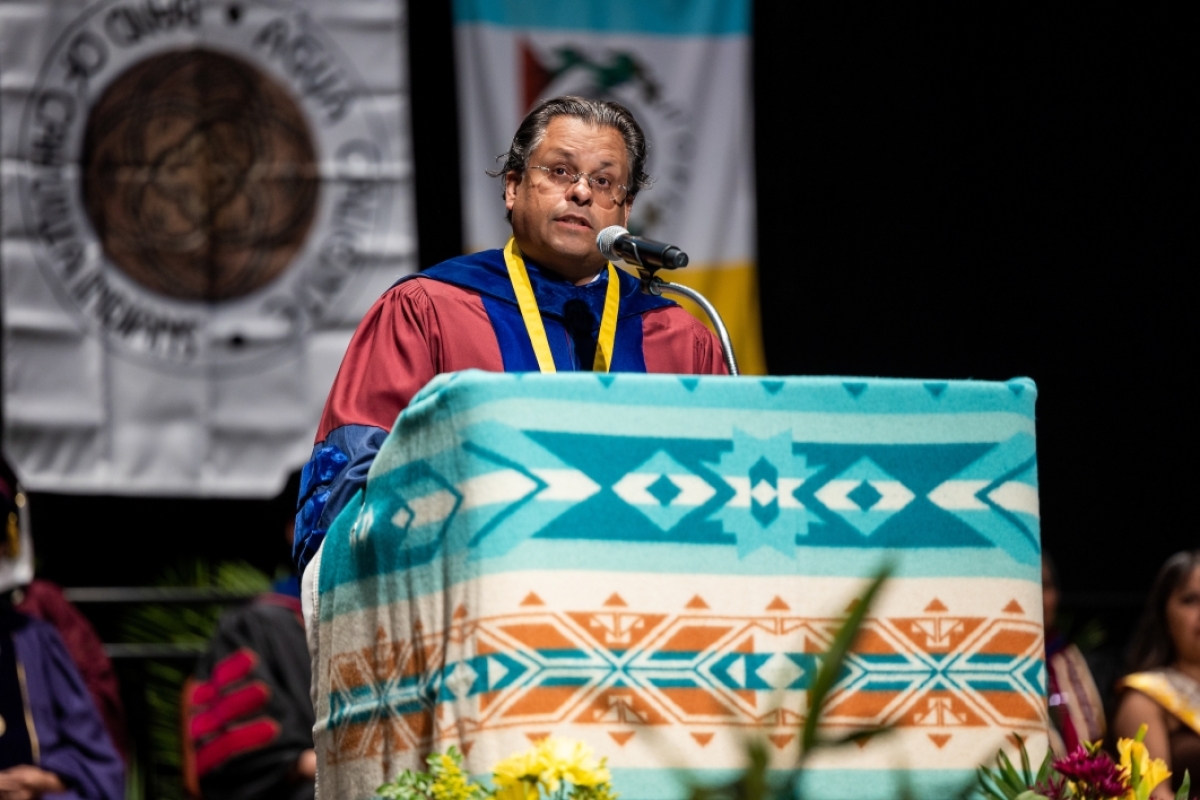 Man speaking at lectern during American Indian convocation