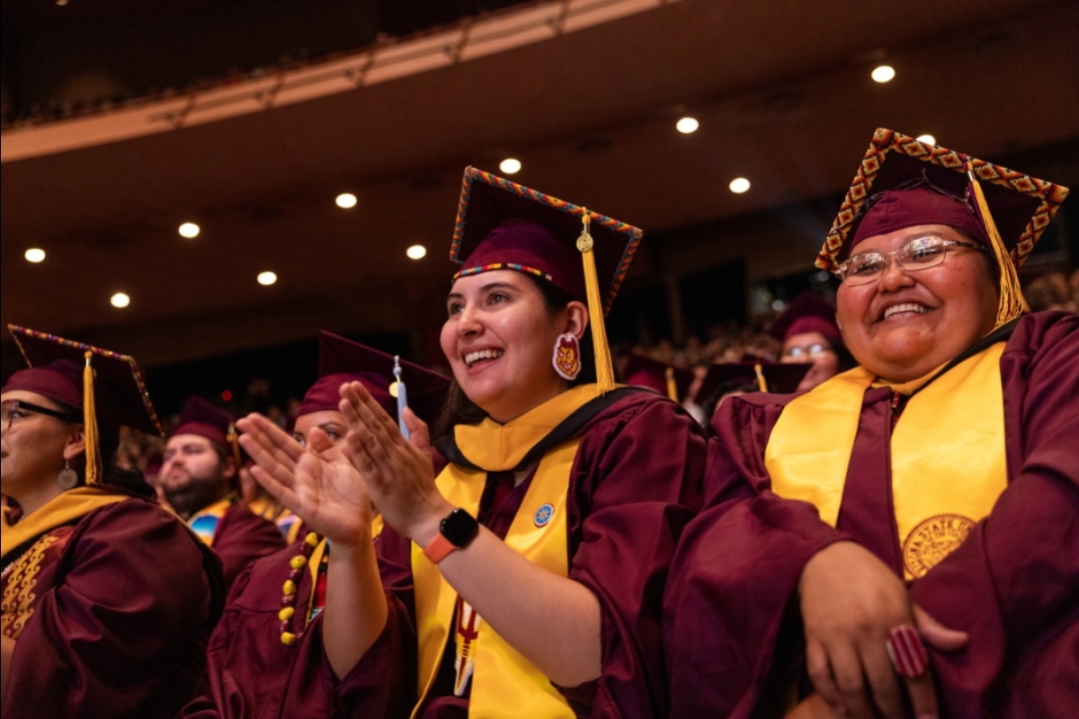 Graduates clapping during convocation at ASU Gammage