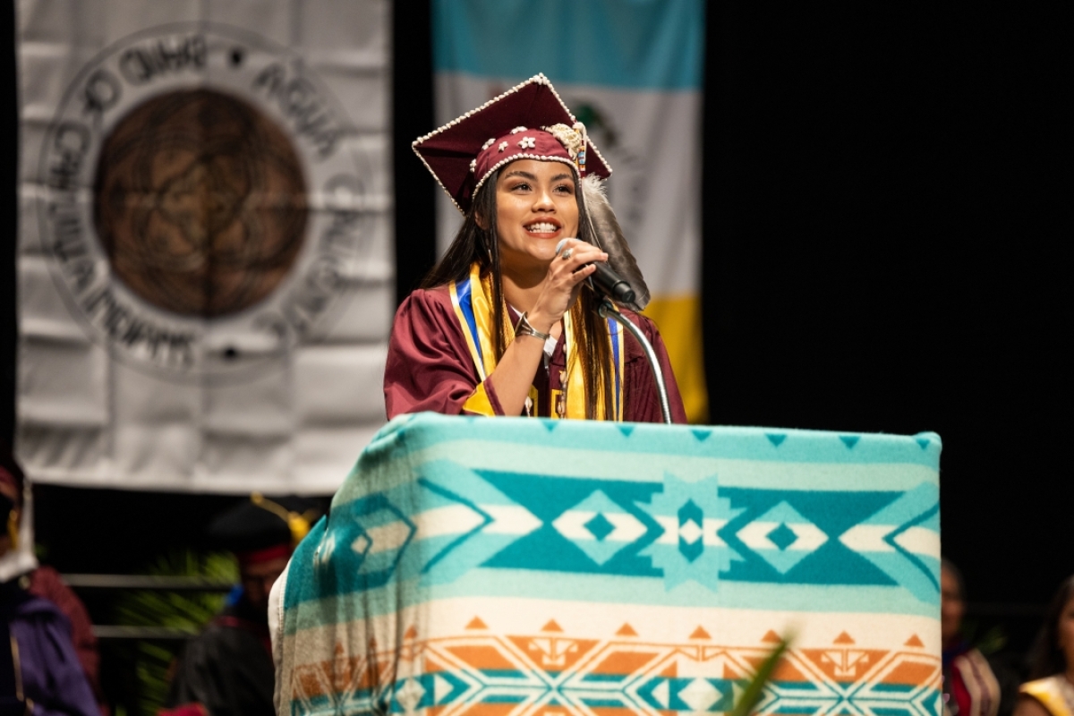 Graduate speaking at lectern during convocation