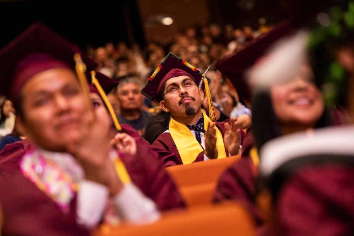Audience of graduates clapping in ASU Gammage during convocation