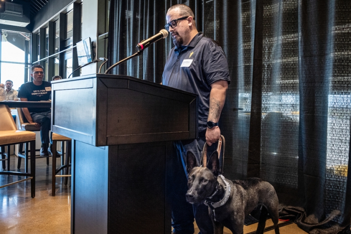 Man with dog at podium