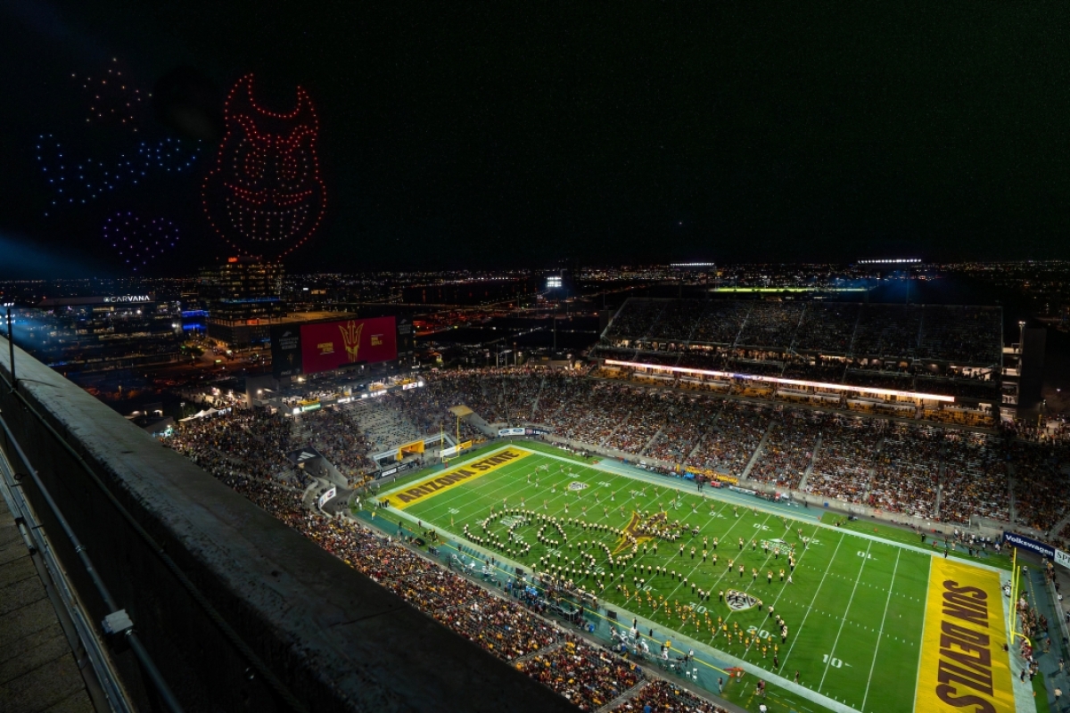 Drones forming an ASU Sparky and the word love hover over the football stadium
