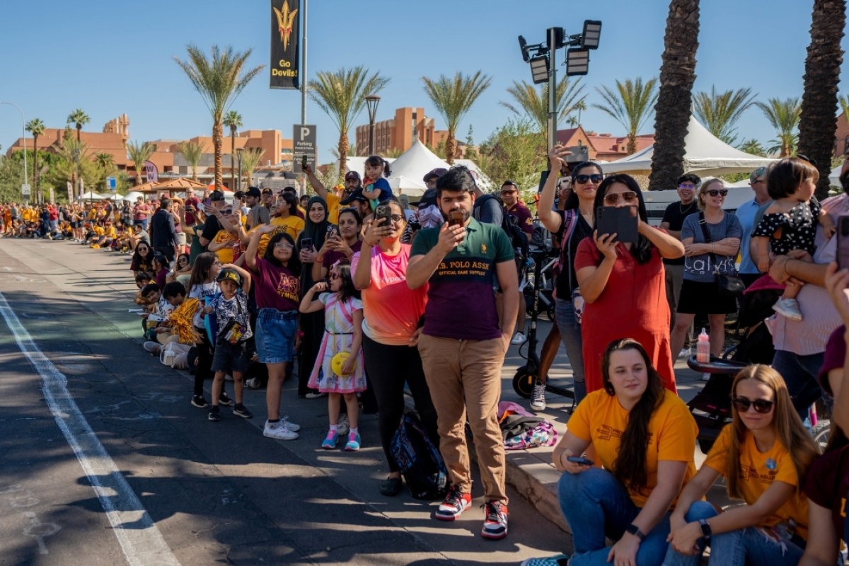 Attendees watch ASU Homecoming Parade in Tempe
