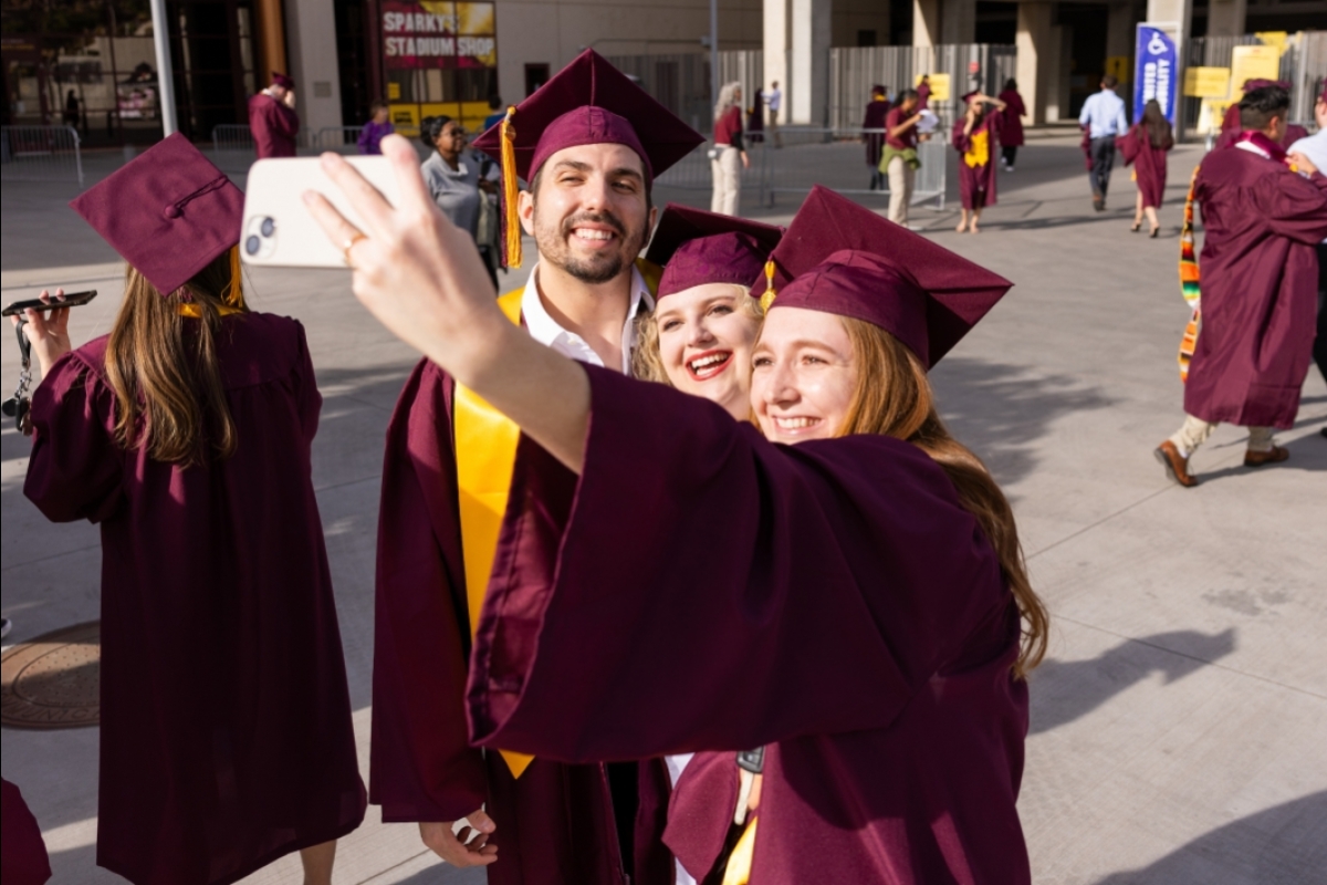 College grads take selfie in caps and gowns