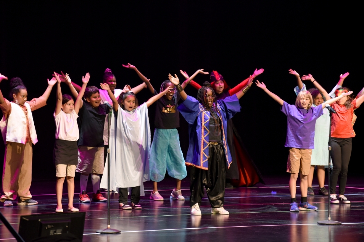 Group of children performing on stage.