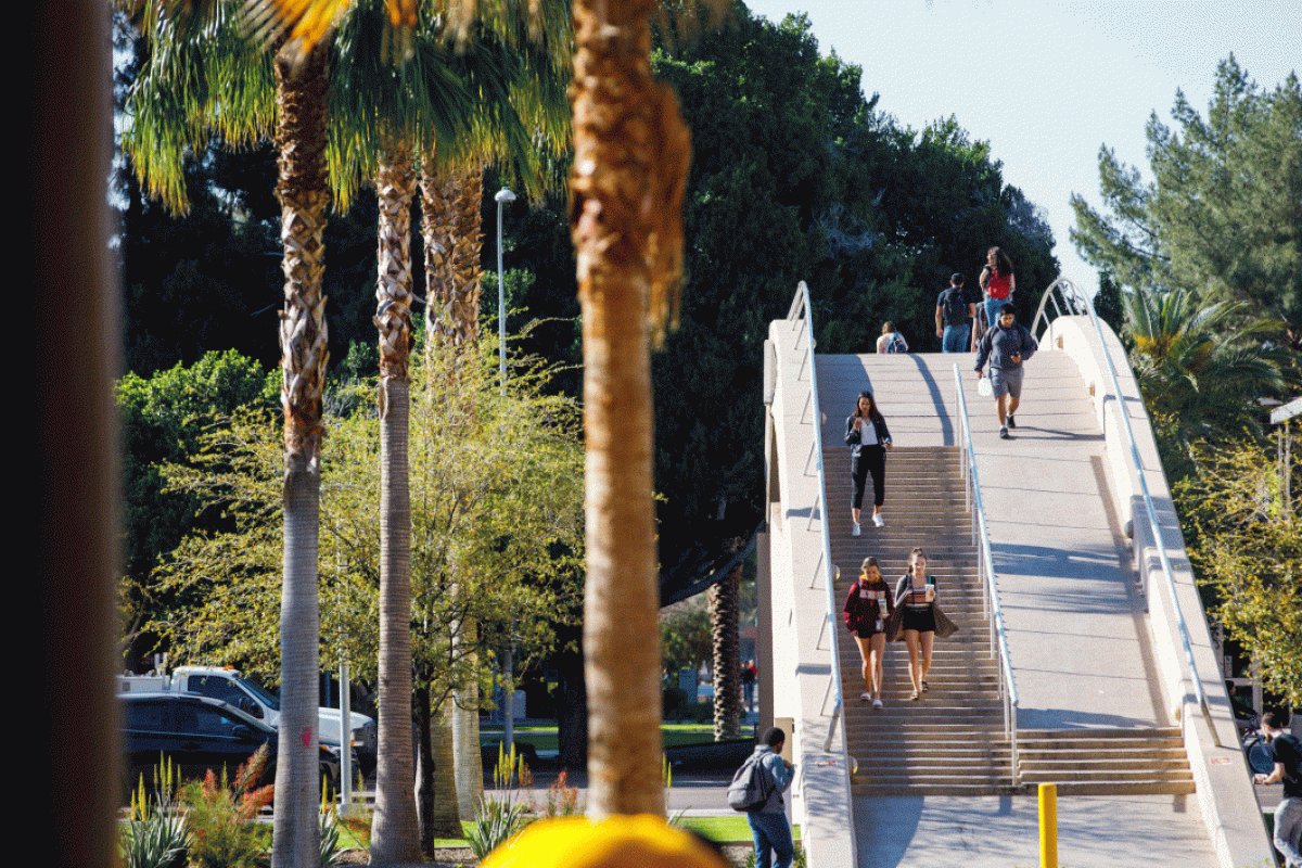 Students walking over pedestrian bridge