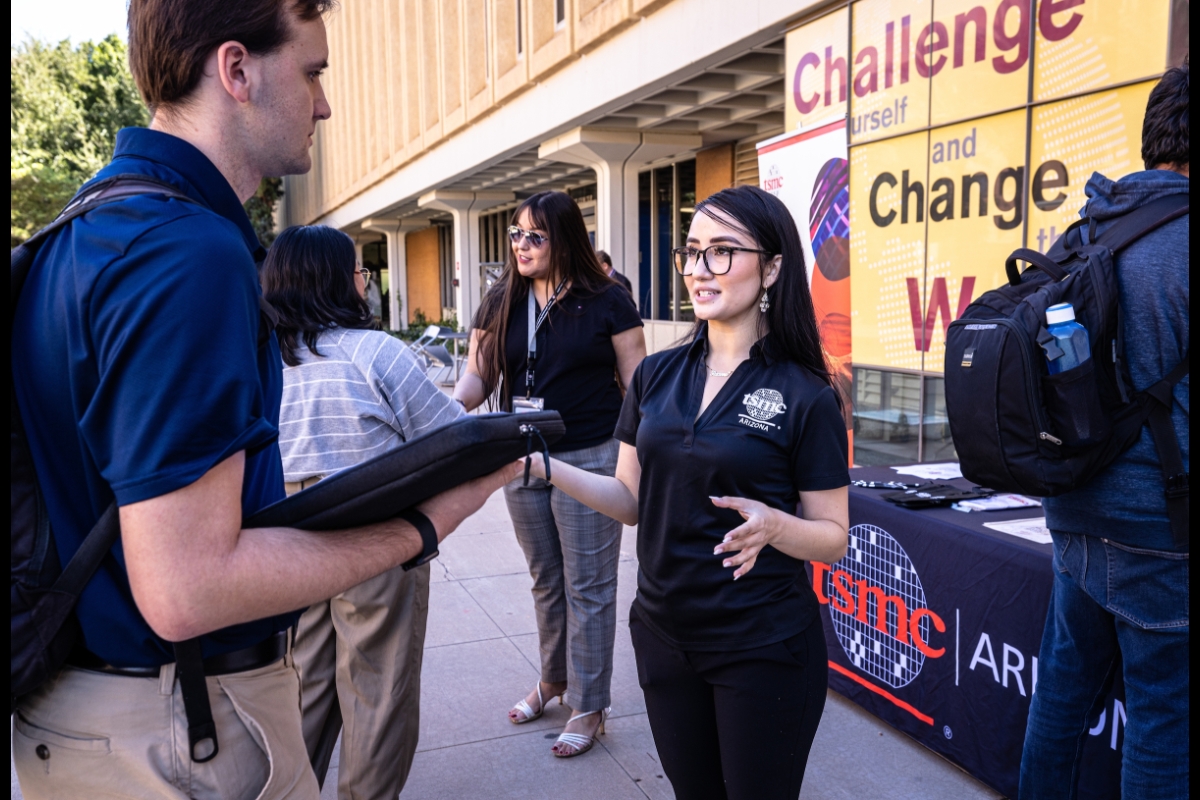 TSMC recruiter talks with students outside an ASU building