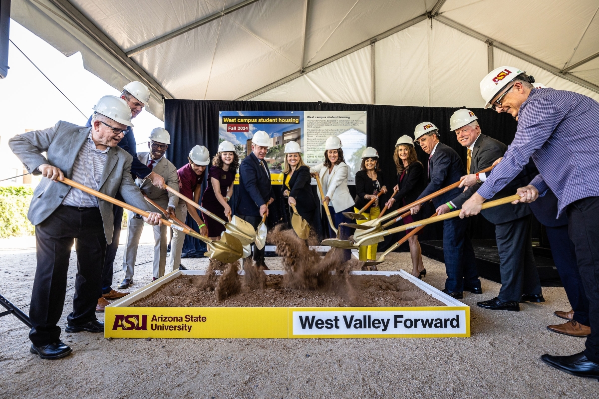 Group of people shovel dirt during groundbreaking ceremony at ASU's West campus