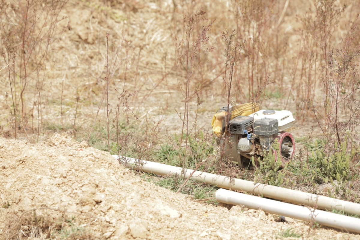 An irrigation pump and pipes in a field.