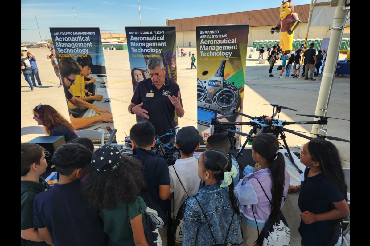 Aviation Assistant Teaching Professor Anthony Wende speaks with school children about drones at the Luke Days STEM City, Friday, March 22. 