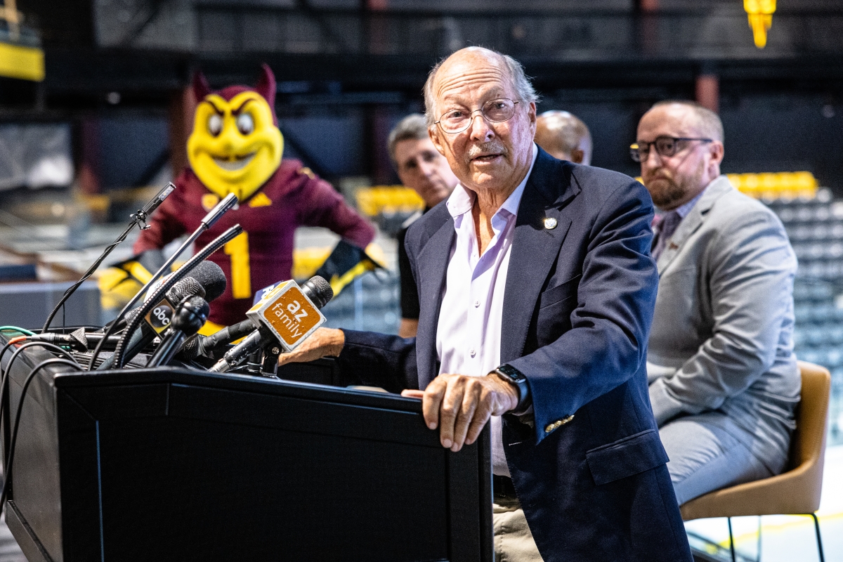 Don Mullett speaks at a podium during a press conference announcing Mullett Arena