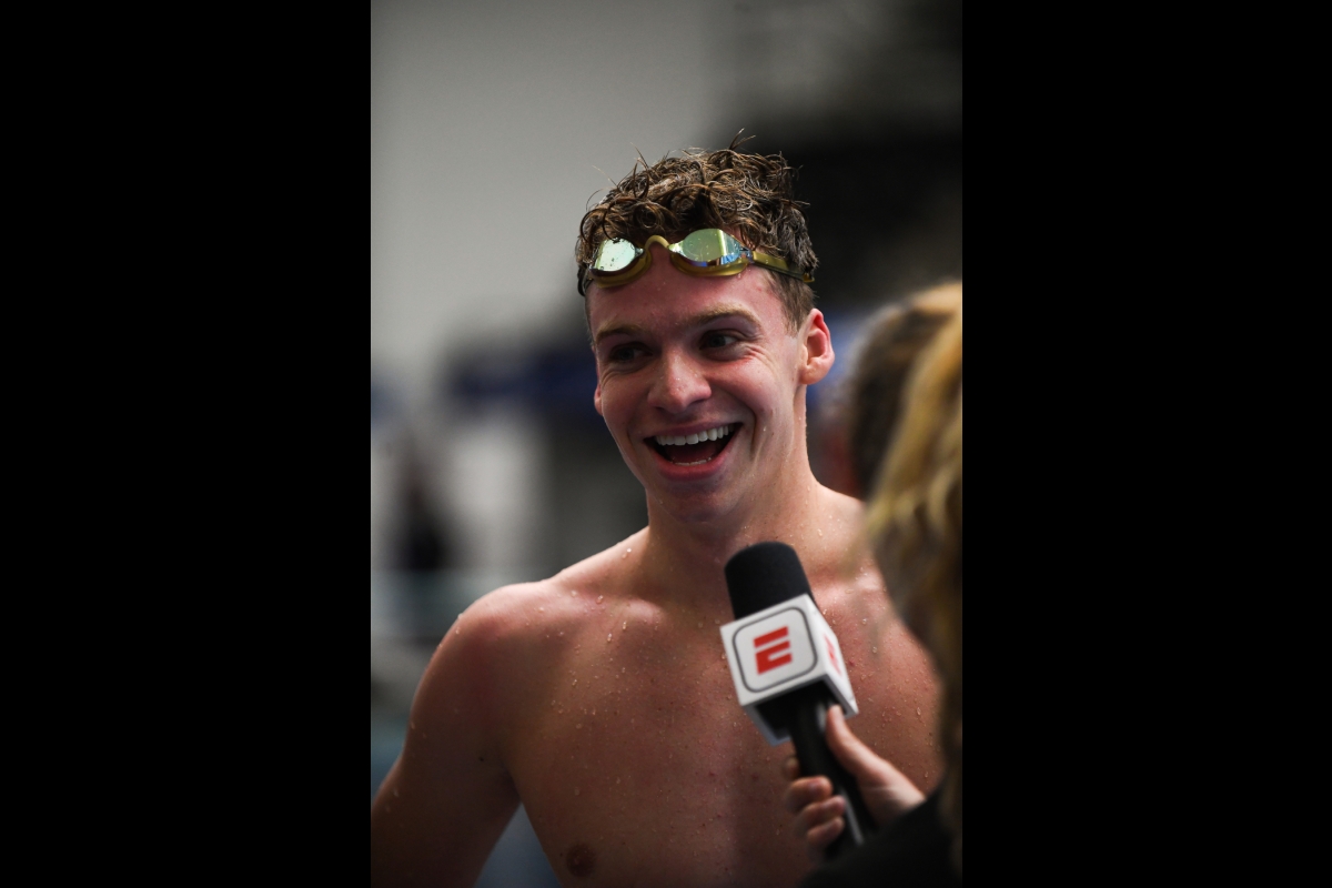 A swimmer smiles as he is interviewed