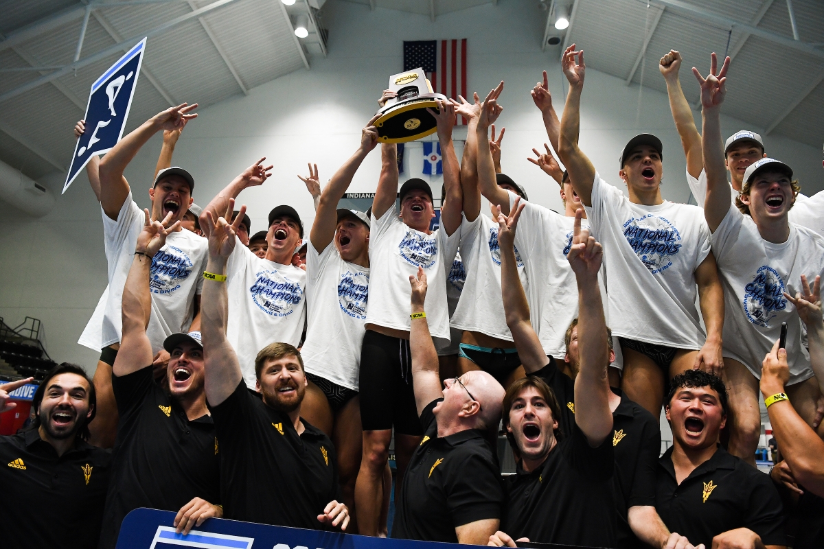 The ASU men's swim team and coaches cheer as they hold the NCAA trophy