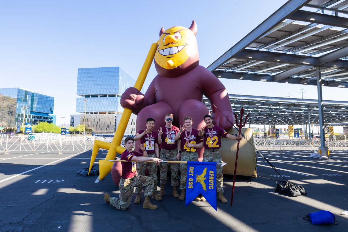 AFROTC members pose in front of inflatable Sparky