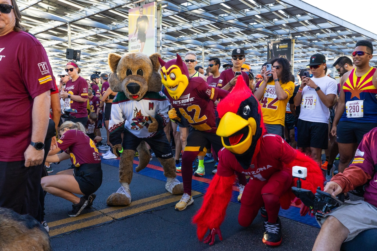 Arizona sports mascots and runners wait at start of race