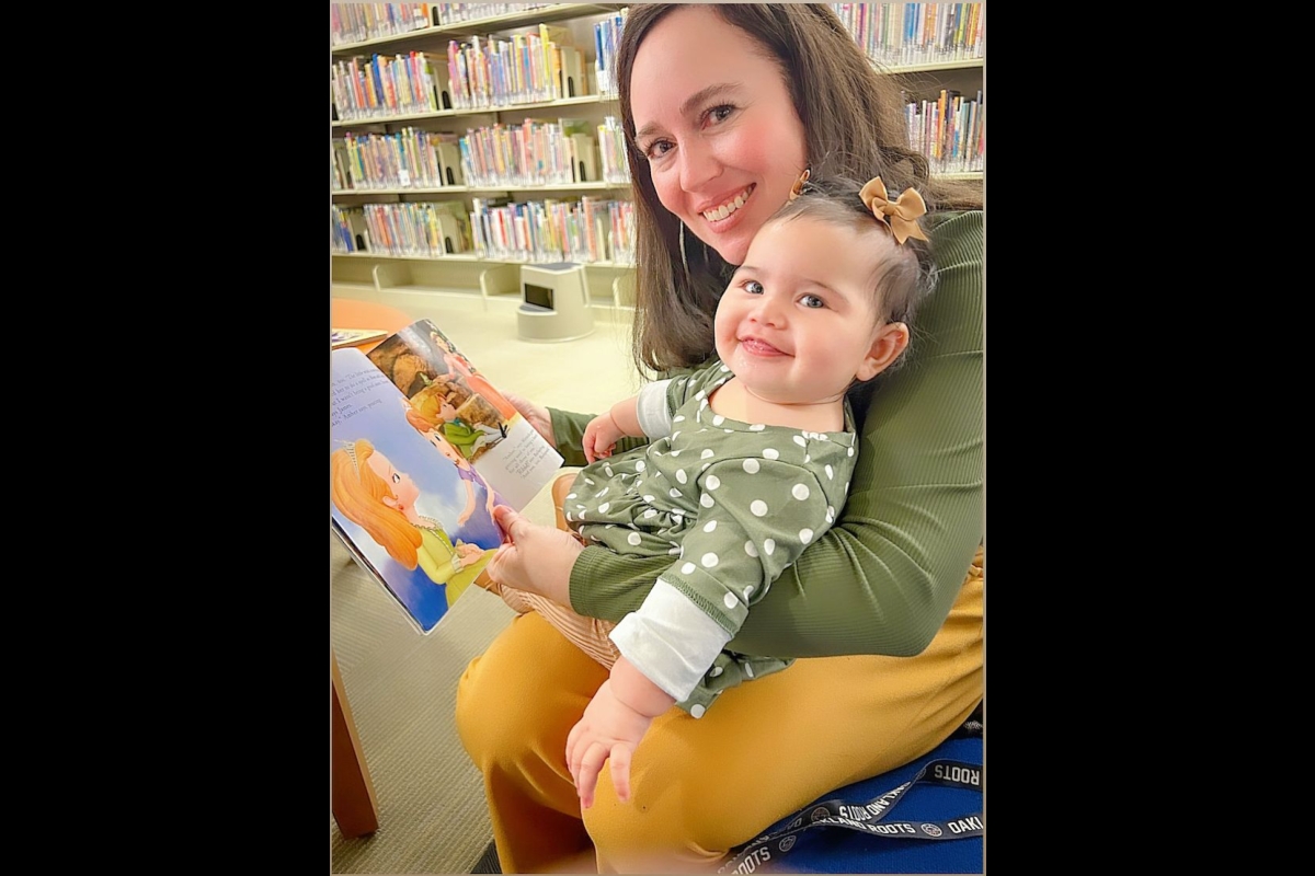 Elisha Hernandez and infant daughter Olivyah Hernandez love reading books together