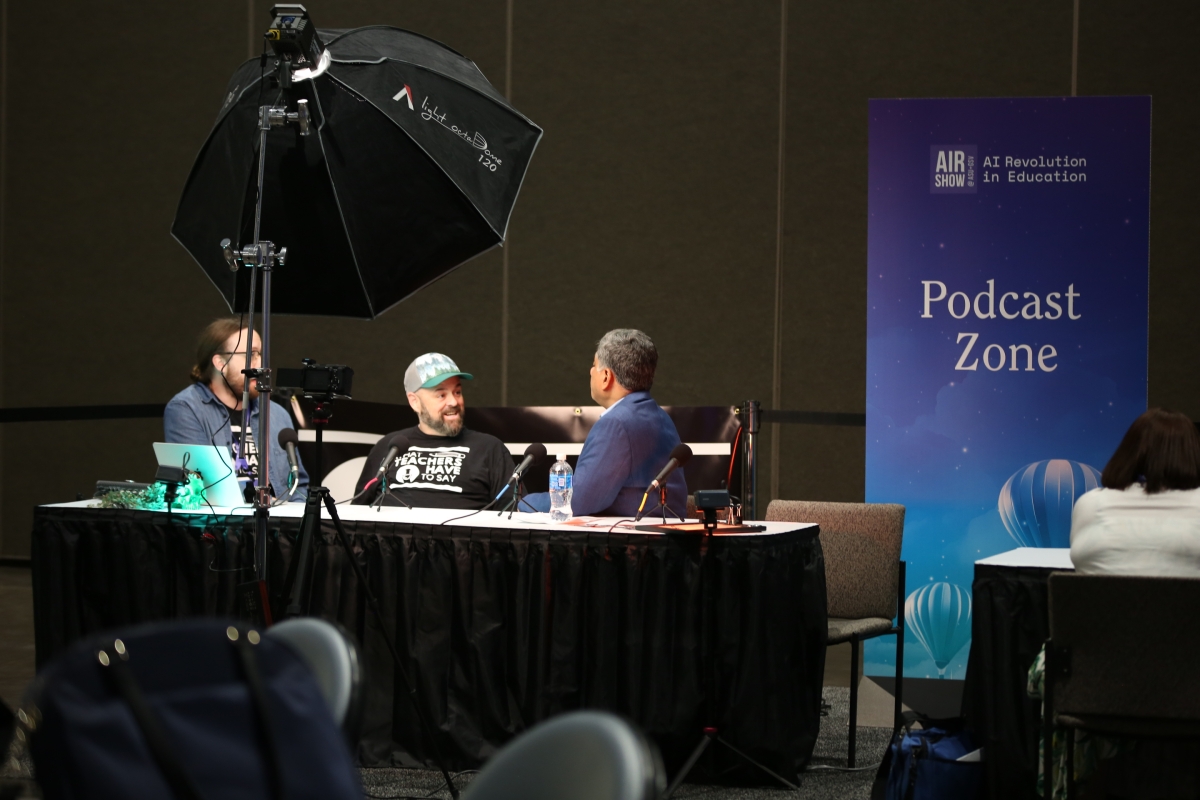 Podcasters recording at table