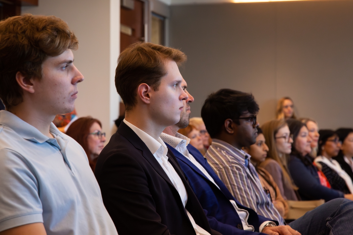 Students listen to speakers during an event
