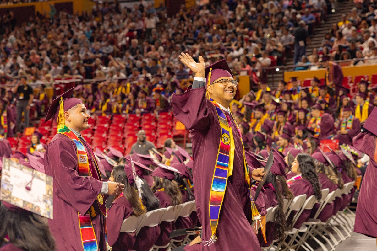 Graduates wave to family and friends during convocation