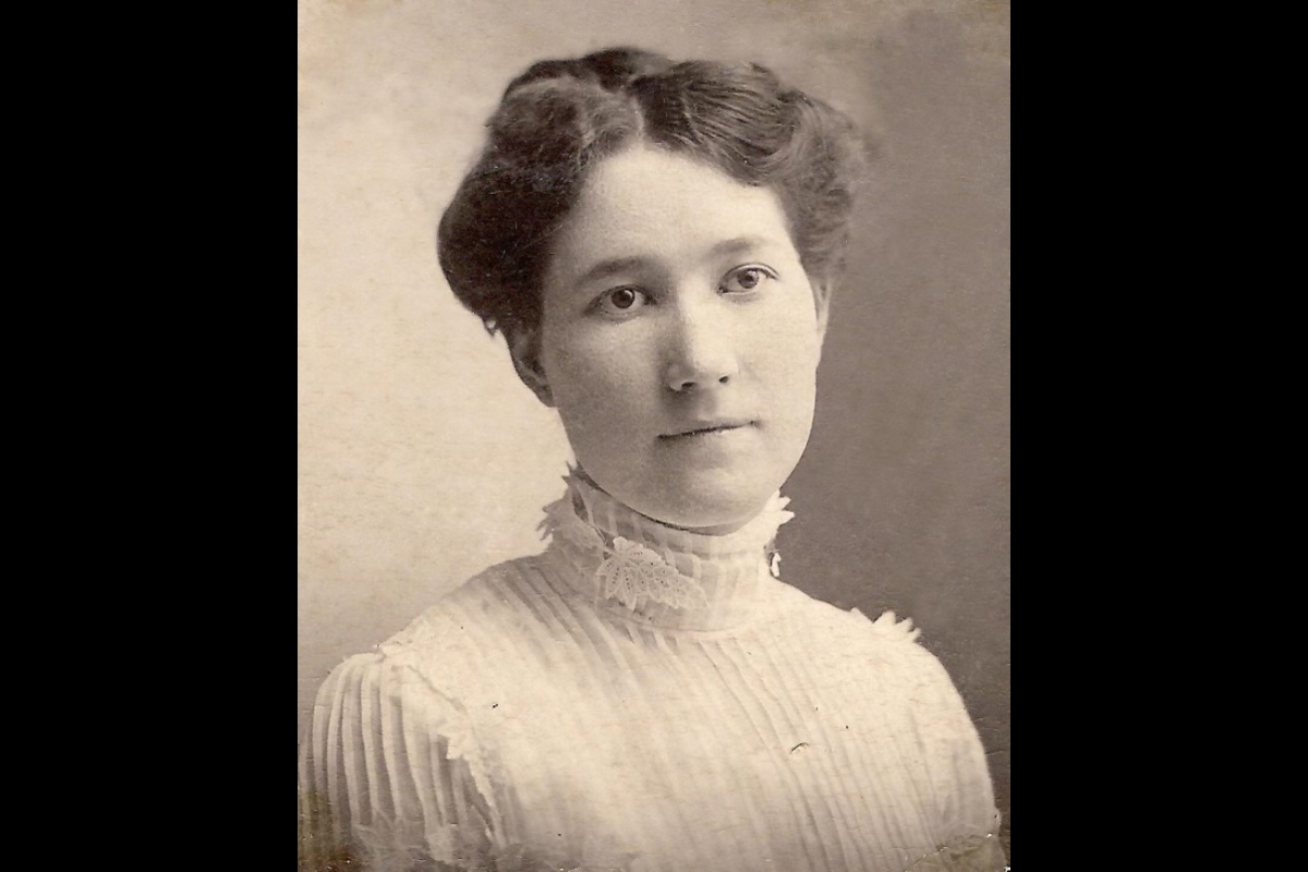 Historical sepia portrait of a young woman from the early 1900s