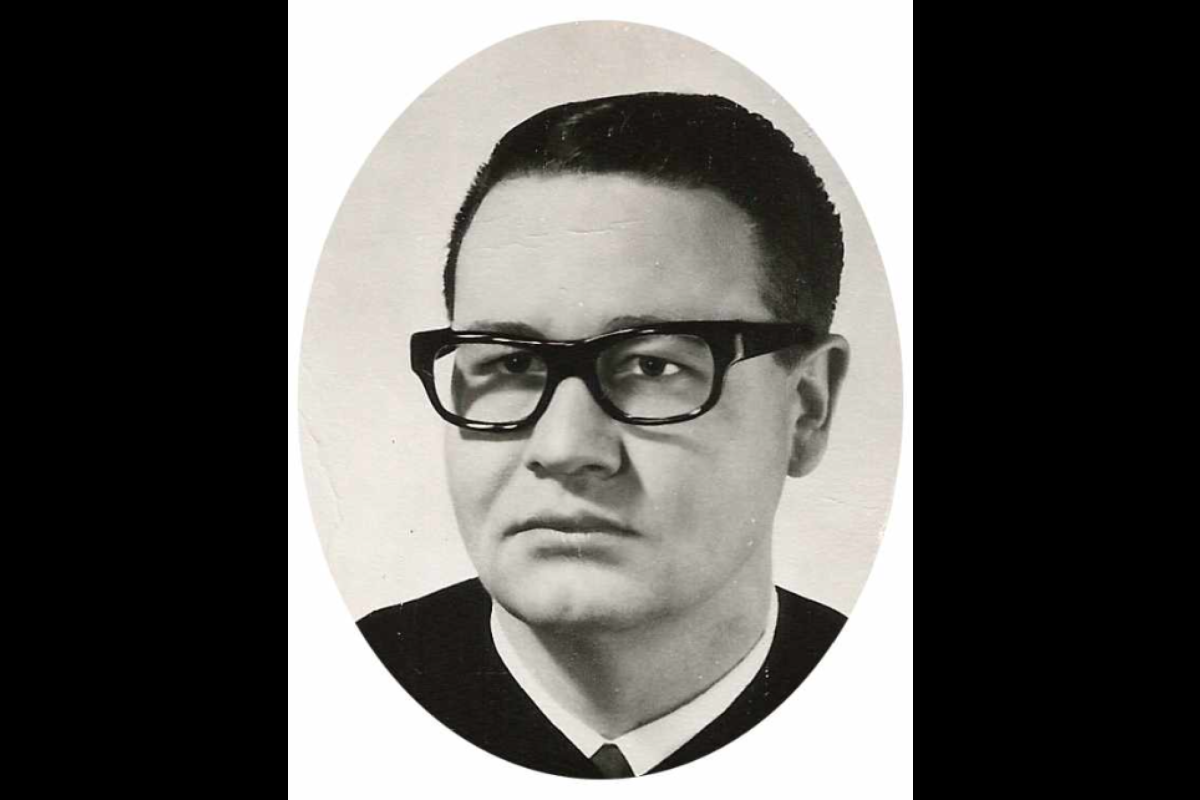 Black and white portrait from the 60s of a man with short hair and glasses