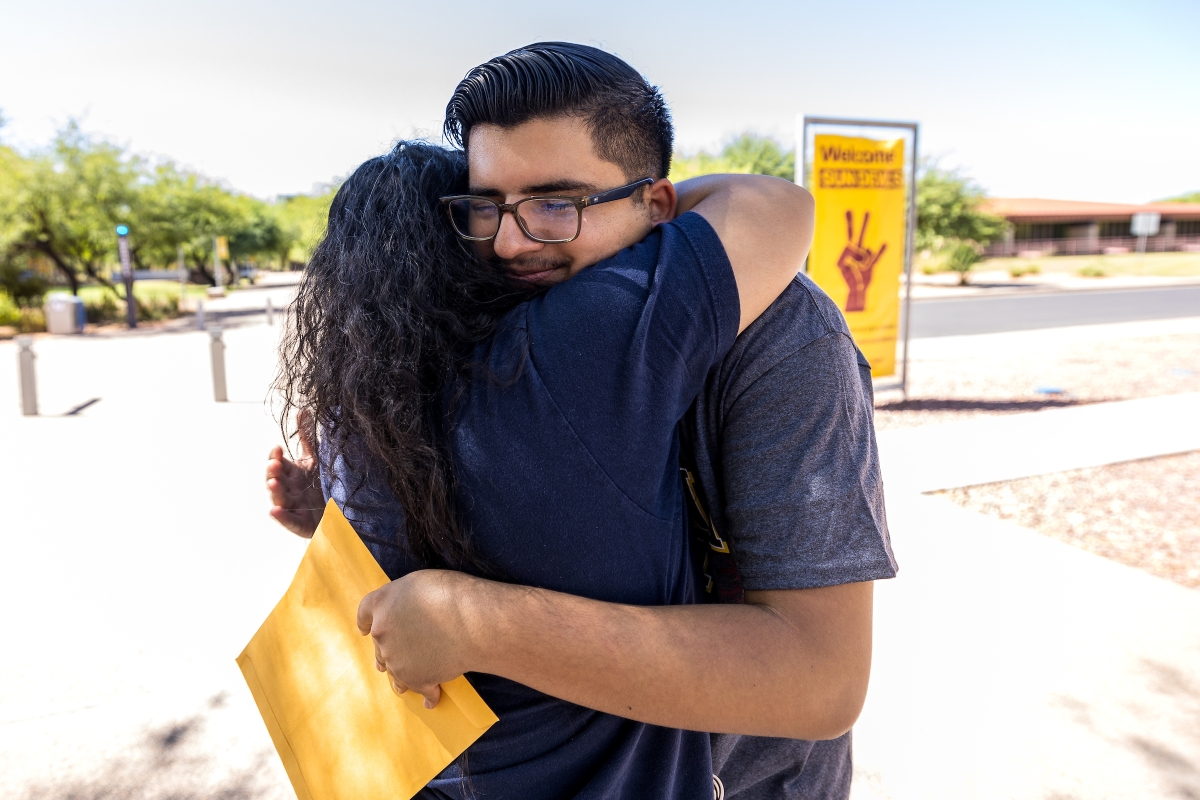 Aunt and nephew embrace as he gets dropped off for college