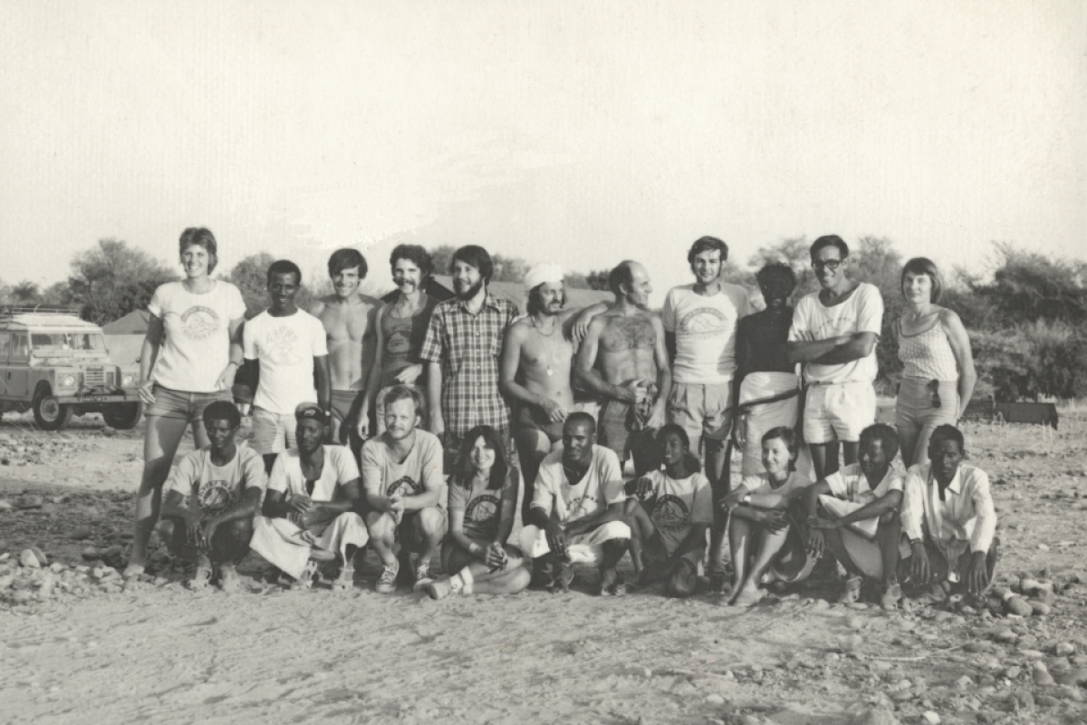 Black and white photo of a large group of researchers in Africa