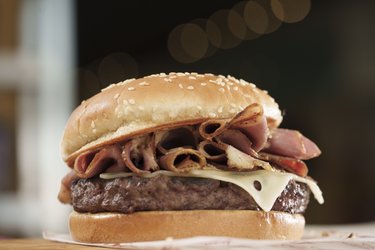 Closeup of a burger with pastrami on it