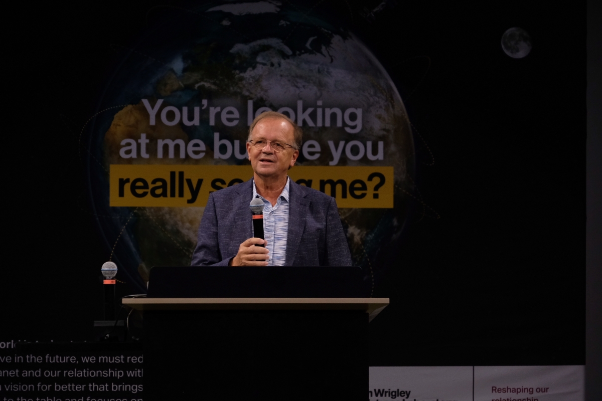 Man behind a lectern speaking into a microphone.