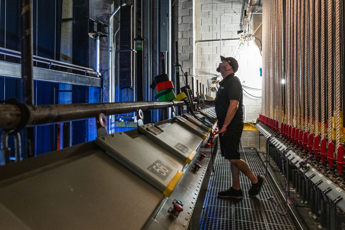 A man works behind a stage