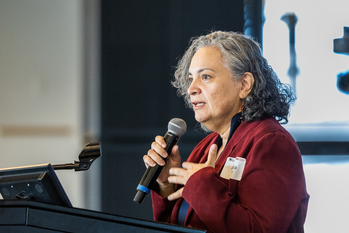 Latina woman holds a microphone