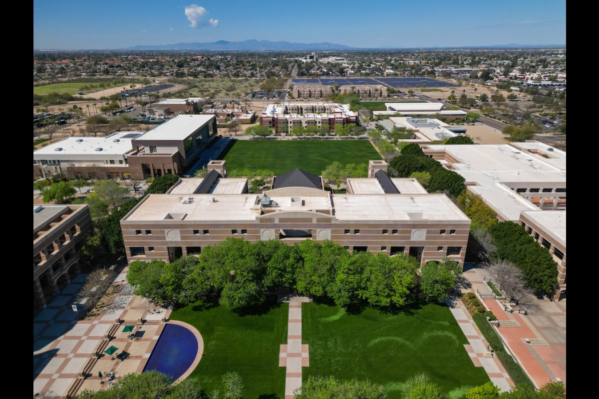 ASU campus buildings as seen from a drone with Phoenix residential homes seen behind it