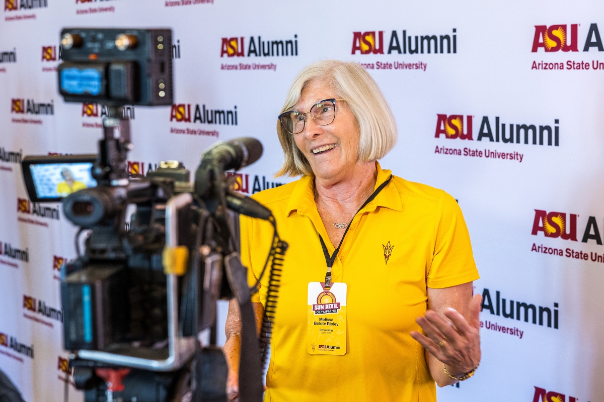 Woman speaking toward a camera.