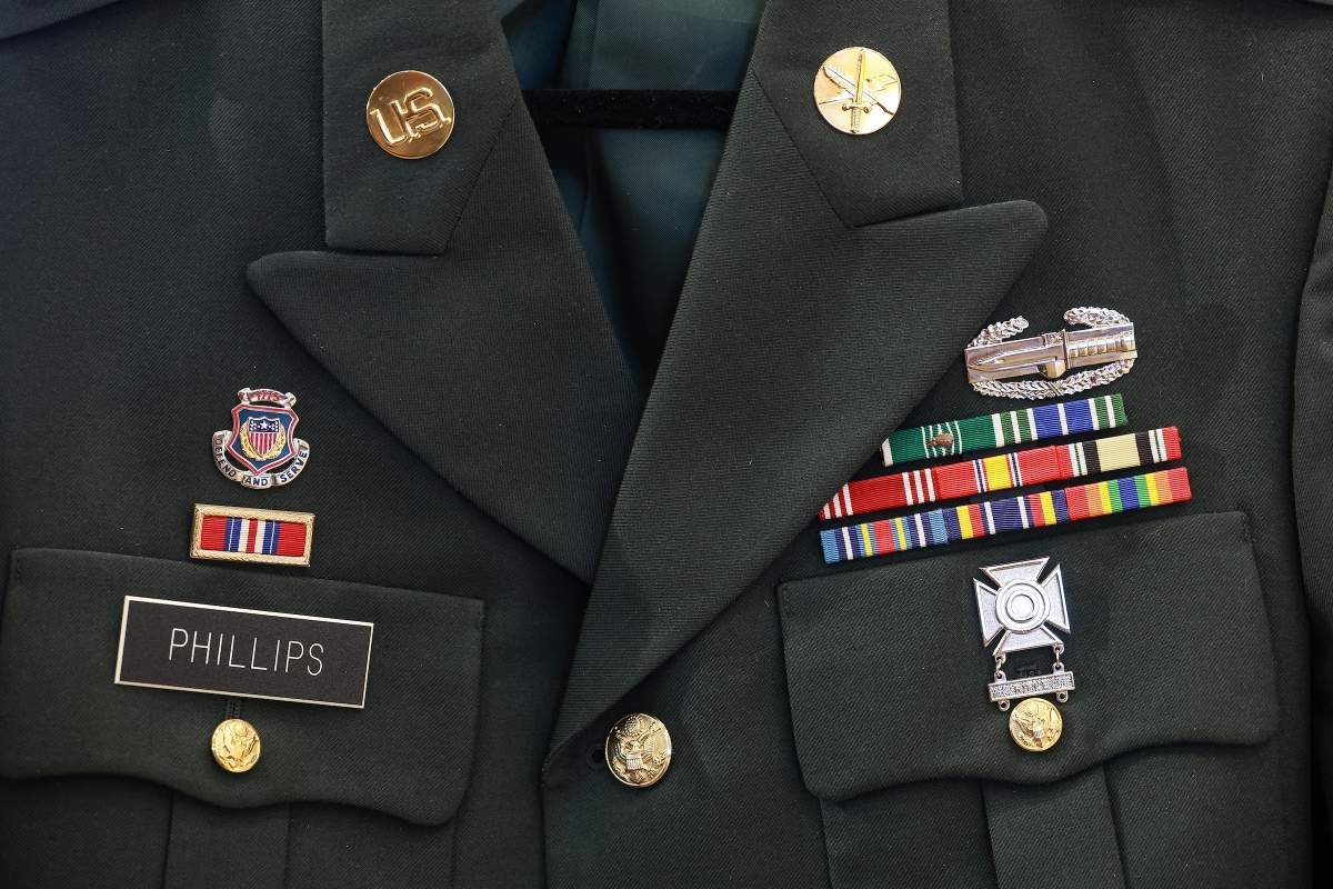 Close-up view of a military uniform with badges and medals.