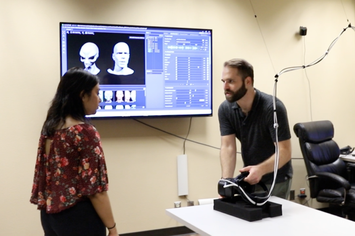 Student listens to professor explaing motion capture technology.