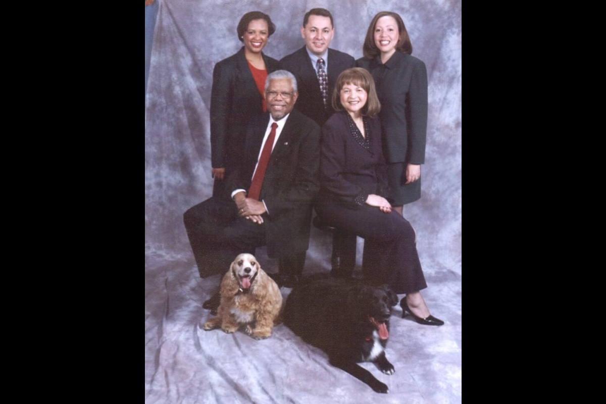 A family of five and two dogs pose for a photo